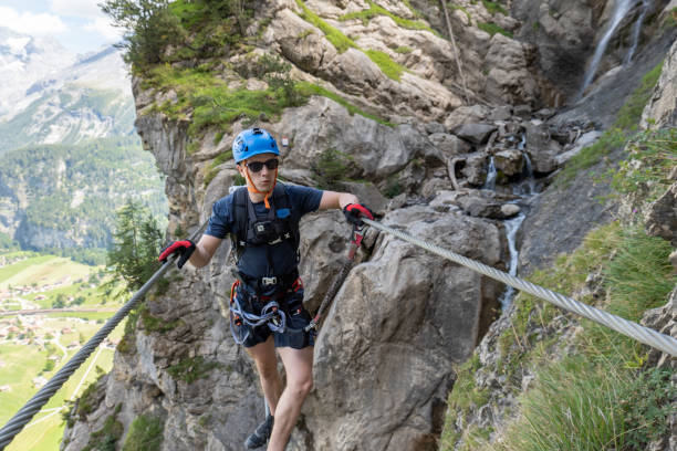 istock Man on Via Ferrata crossing on a suspension bridge 1495650663