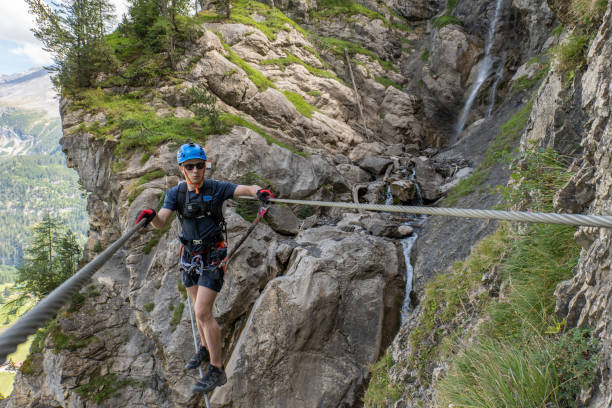 istock Man on Via Ferrata crossing on a suspension bridge 1495650669