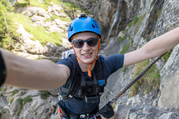 istock Man taking selfie on Via Ferrata while climbing 1495650724