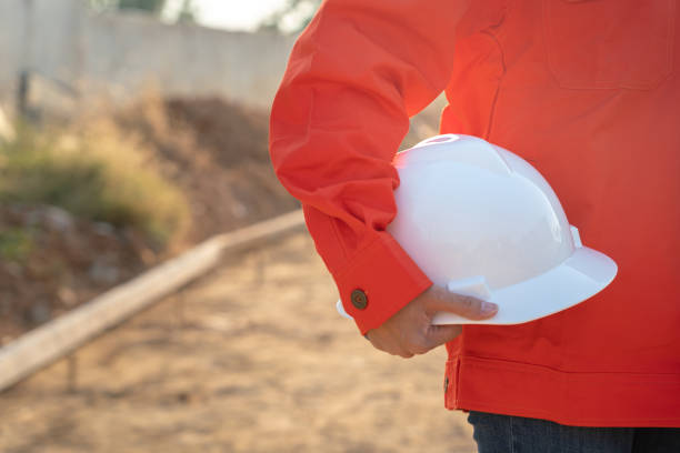 istock Engineer holding safety helmet at construction site. 1495651458