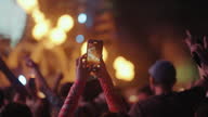 istock People are about to record a concert with their mobile phones. 1495653225