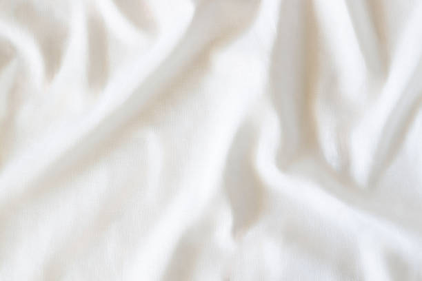 istock White crumpled linen fabric texture background. Natural linen organic eco textiles canvas background. Top view 1495655704