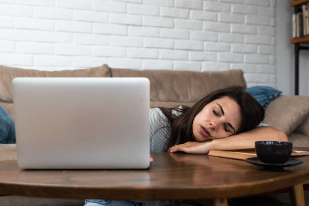 istock Tired, exhausted freelancer woman with a laptop, problems with the project, feeling depressed, laziness in the home office in the living room. Stressed student girl overworked burnout with study 1495656428