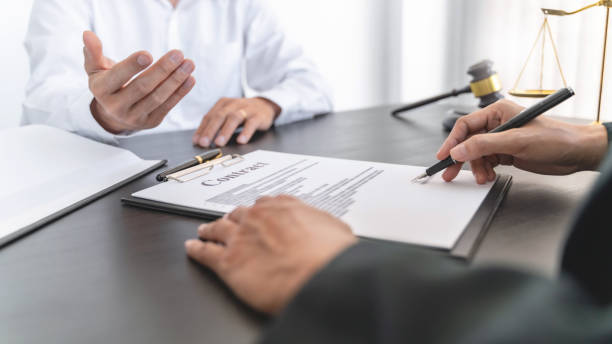 istock Lawyer preparing to sign a contract reading documents at meeting 1495656783
