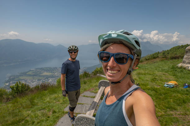 istock Mountain biking couple pause on mountain top 1495657372