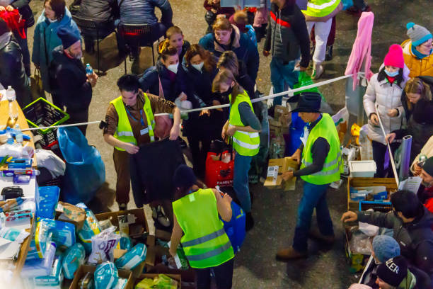 Volunteers help refugees from Ukraine at the railway station in Warsaw, Poland stock photo