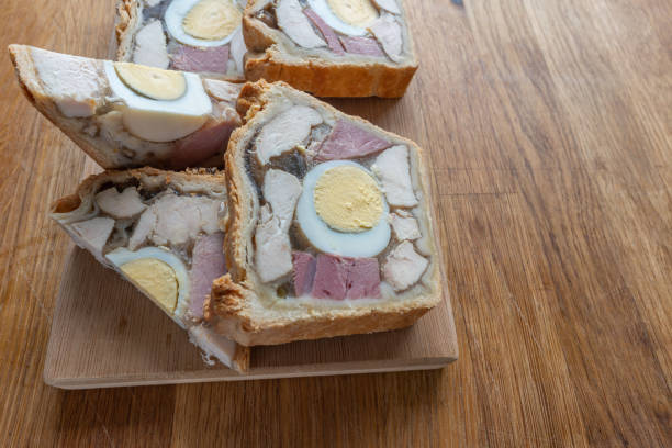 istock Chicken Ham and Egg Pie, ready portion showing lovely pieces of cooked meat and boiled egg 1495658582