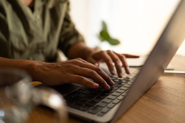 Close up on woman hand typing on keyboard