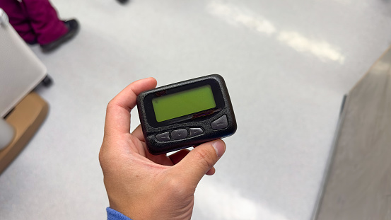 Beeper pager symbolizes communication, urgency, and efficiency in business and hospital settings. It represents the need for immediate response and coordination in professional environments