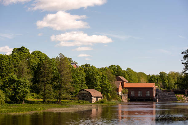 an old hydroelectric power station by a beautiful river in Finnish summer