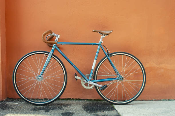 istock Retro fixed gear bicycle on brown concrete wall background 1495664143