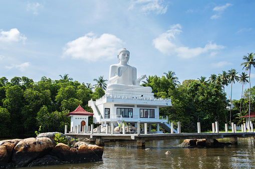 Bentota, Sri Lanka - April 15, 2018: state of white sitting Buddha