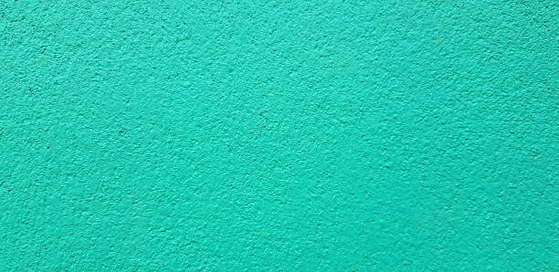 istock Light green painted Rough or grunge concrete or cement wall for background. 1495668318