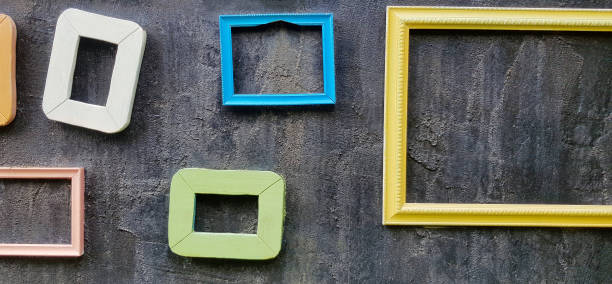 istock Many colorful empty picture frame hanging or isolated on rough black wall for decoration festival 1495668359