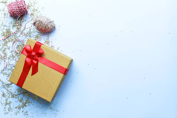 istock Gift wrapping. Christmas present on a blue background. Glitter, shine 1495679608