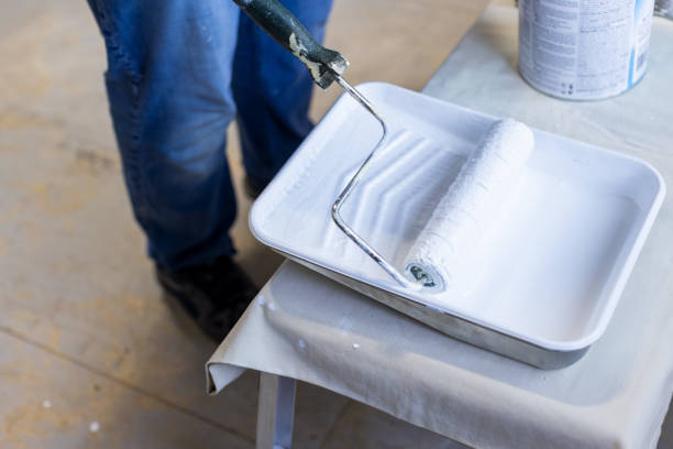 istock Person putting paint on a paint roller 1495682614