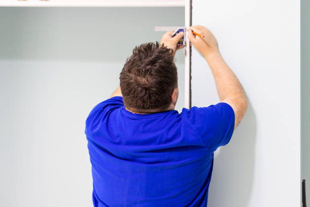 istock A man is making measures for door trims installation 1495683146