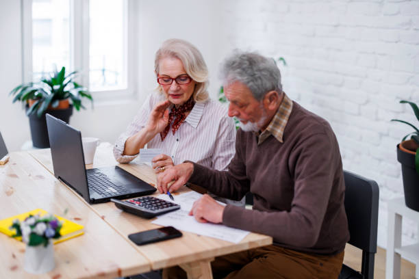 istock A senior couple is using a credit card and laptop for checking financial status. 1495684751