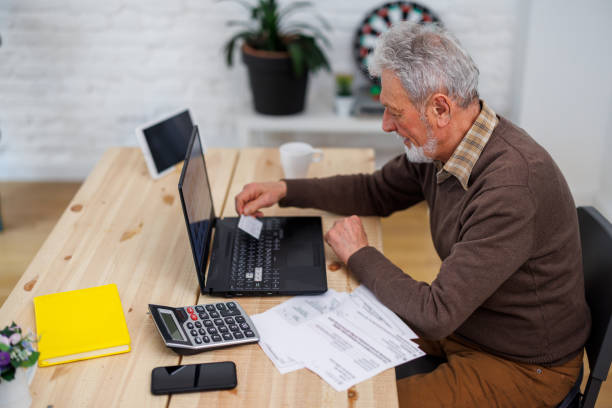istock A senior man is working at Home while making plans for online shopping. 1495684768