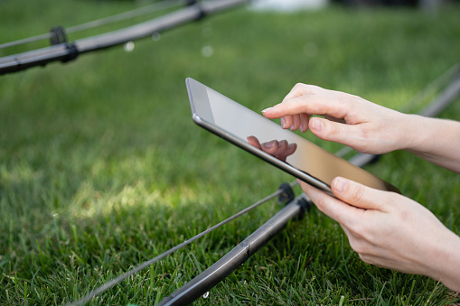 Farmer controls drip irrigation system with digital tablet