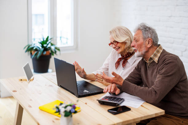 istock A senior confident business couple is working from home while having a video conference on a laptop. 1495685338