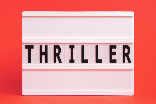 The word thriller on lightbox isolated red background. Literary Genres
