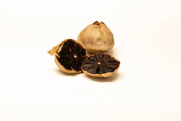 A pile of smoked garlic for sale at a market.