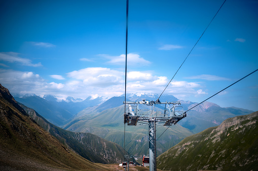 Mountain ranges on a sunny day at Georgia. Funicular in the mountains of georgia. Mountain cable car in summer