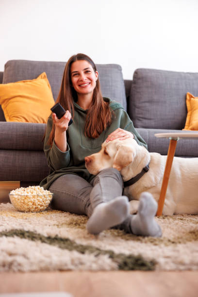 istock Woman and dog watching TV 1495694594