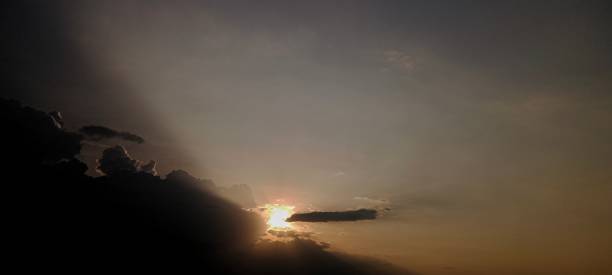 wolken mit gelbem licht - heaven hell road sign sign stock-fotos und bilder