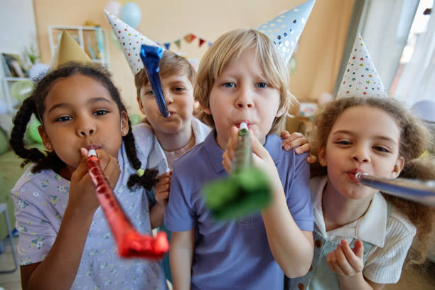 istock Three children holding party blowers and having fun 1495695014