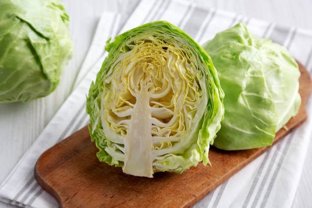 istock Raw Organic Cabbage on a Rustic Wooden Board, low angle view. 1495695839