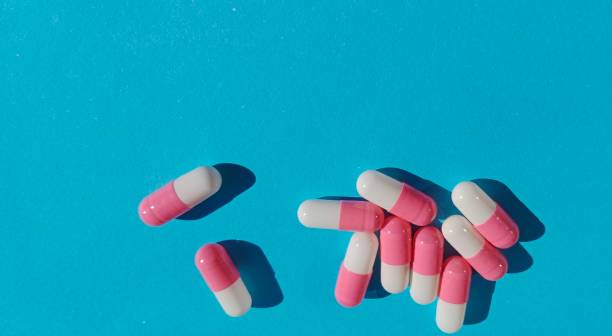 istock pill capsules with red and white colors on a blue background 1495696146