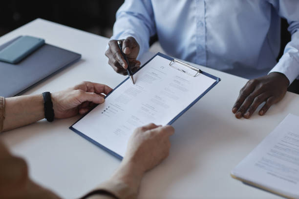 istock Candidate handing CV to recruiter at job interview 1495696951