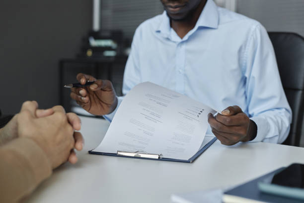 istock Black man reviewing CV during job interview 1495696954