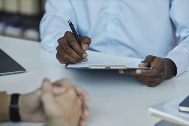 istock Unrecognizable HR recruiter reviewing CV during job interview 1495696955