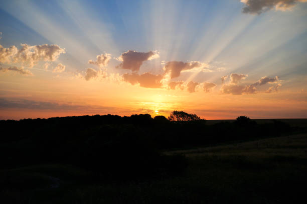 istock Sun rays in the sunset or sunrise over the countryside 1495698029