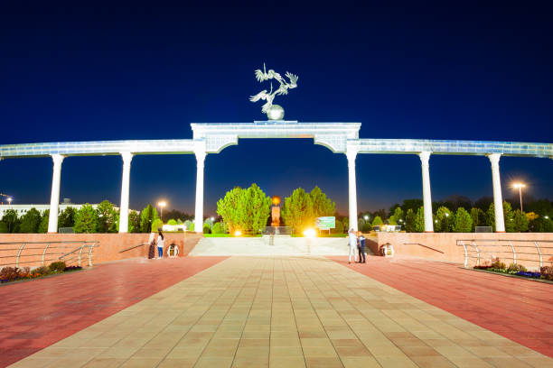 Storks flying over the globe in the Ezgulik Arch of Good and Noble Aspirations at Independence square, Tashkent city in Uzbekistan at night