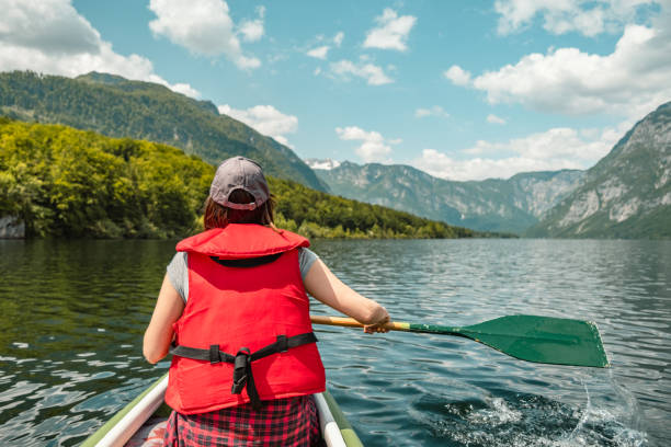 istock A woman in a canoe on a mountain lake. 1495701897