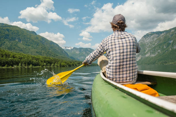 istock A man in a canoe on a mountain lake. 1495701920