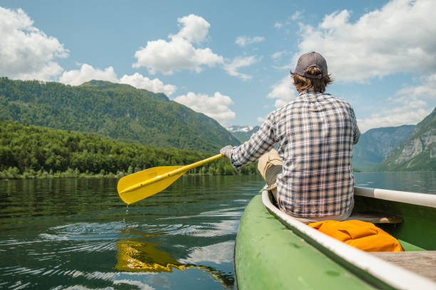 istock A man in a canoe on a mountain lake. 1495701928
