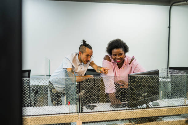 istock coworkers are in the office in different types of activities but both in work function 1495702029