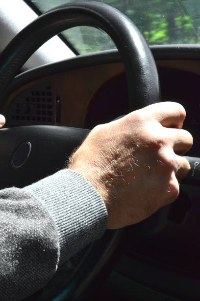 istock a man drives a car and holds the steering wheel 1495703123