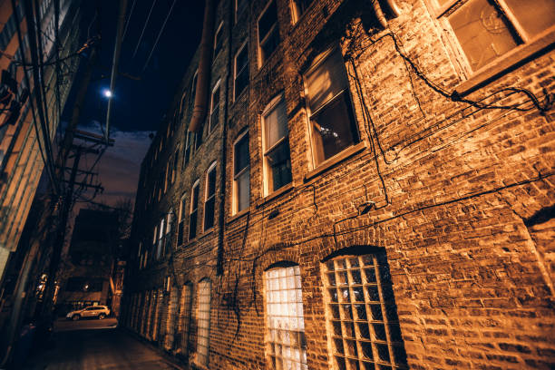 House window in a snow and burning lamp on the brick wall background with copy space.