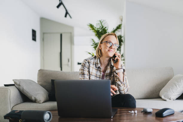 istock Working at home. Woman working remotely using laptop and smart phone 1495712420