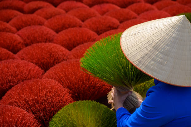 istock Anonymous Vietnamese vendor in field colorful incense sticks 1495716066