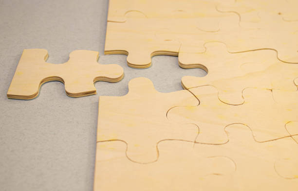 istock Top view flat lay of paper plain white jigsaw puzzle game texture last pieces for solve and place. 1495721083