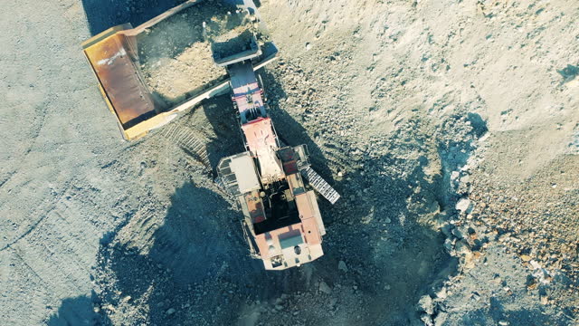 Excavator is digging copper ore in a top view