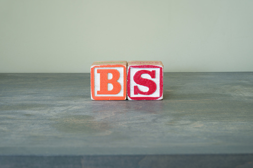 Colorful toy wooden blocks spelling out the word BS