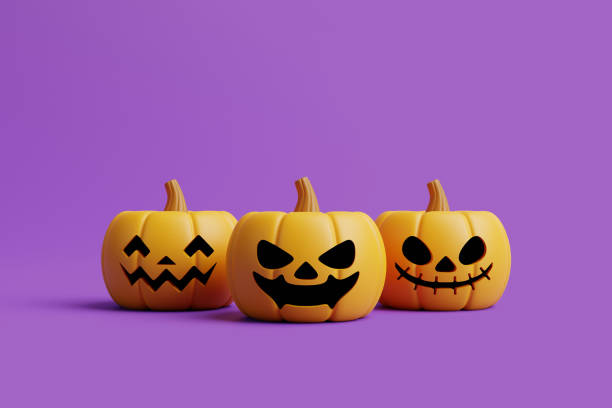 istock Jack-o-Lantern pumpkins on purple background 1495733579